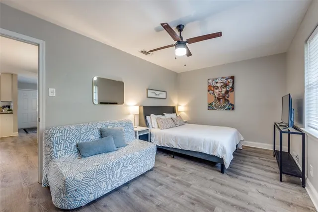 a living room with furniture and a ceiling fan