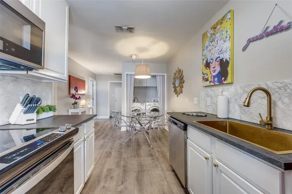 a kitchen with a sink stove and microwave
