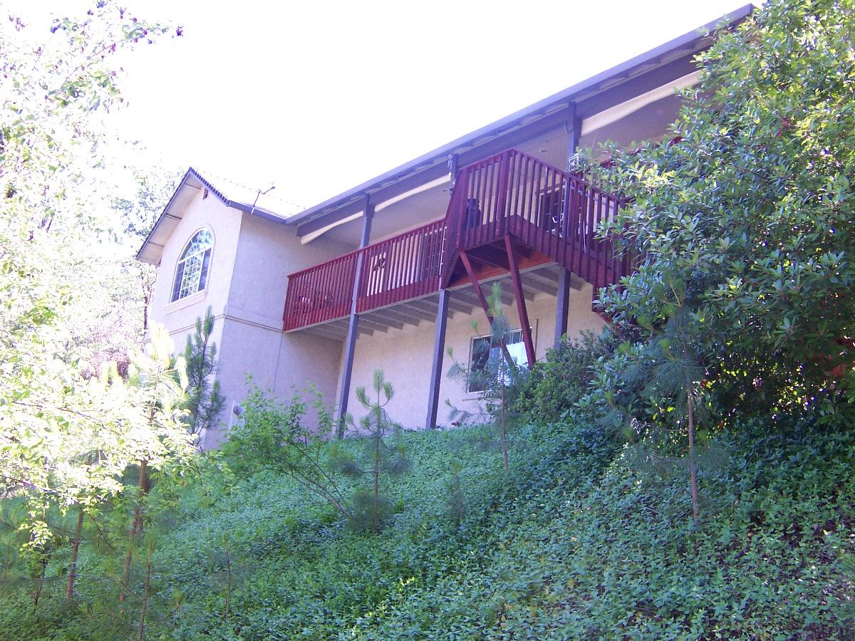 22211 Sunshine Way Redding, CA 96003 - Photo 1 of 2 a red brick building with trees in front of it