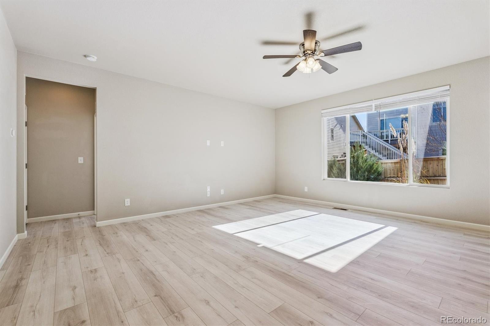 767 Wagon Bend Road Berthoud, CO 80513 - Photo 11 of 21 an empty room with fan and windows