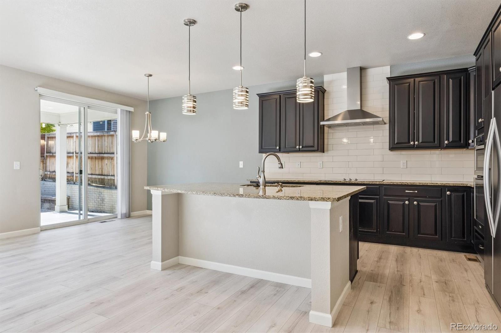767 Wagon Bend Road Berthoud, CO 80513 - Photo 2 of 21 a kitchen with kitchen island a counter top space a sink and appliances