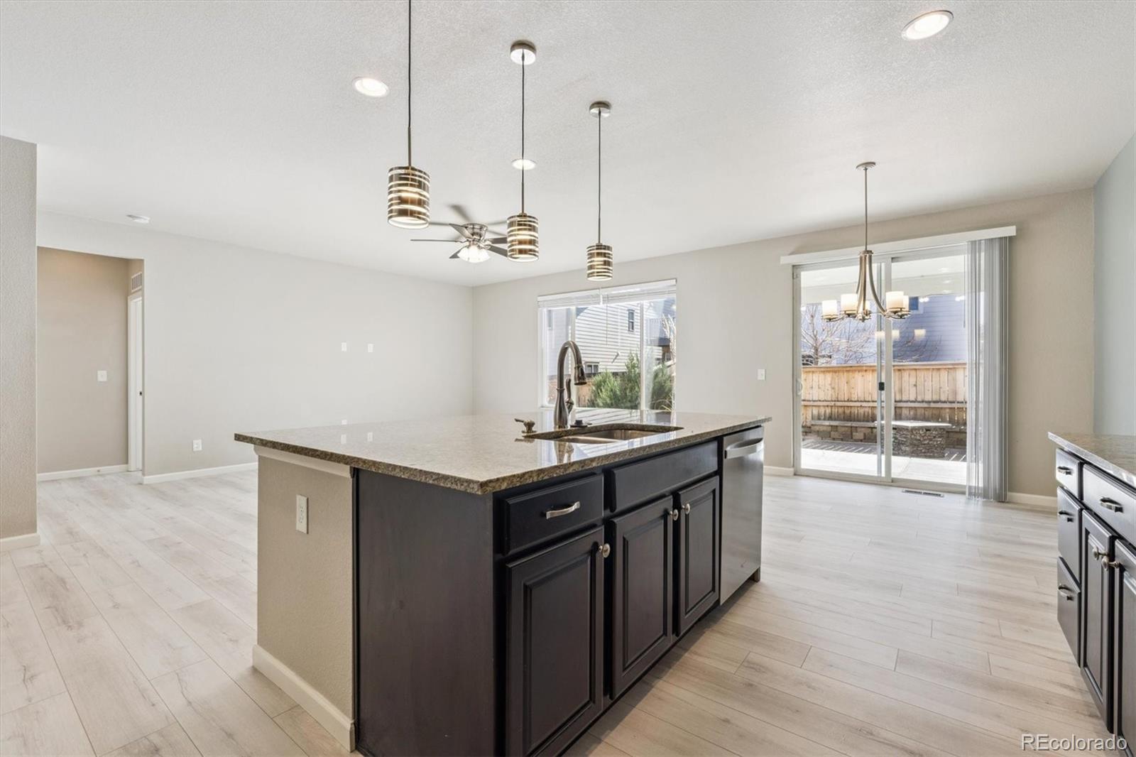 767 Wagon Bend Road Berthoud, CO 80513 - Photo 3 of 21 a kitchen with stainless steel appliances a sink a stove a refrigerator and wooden floor