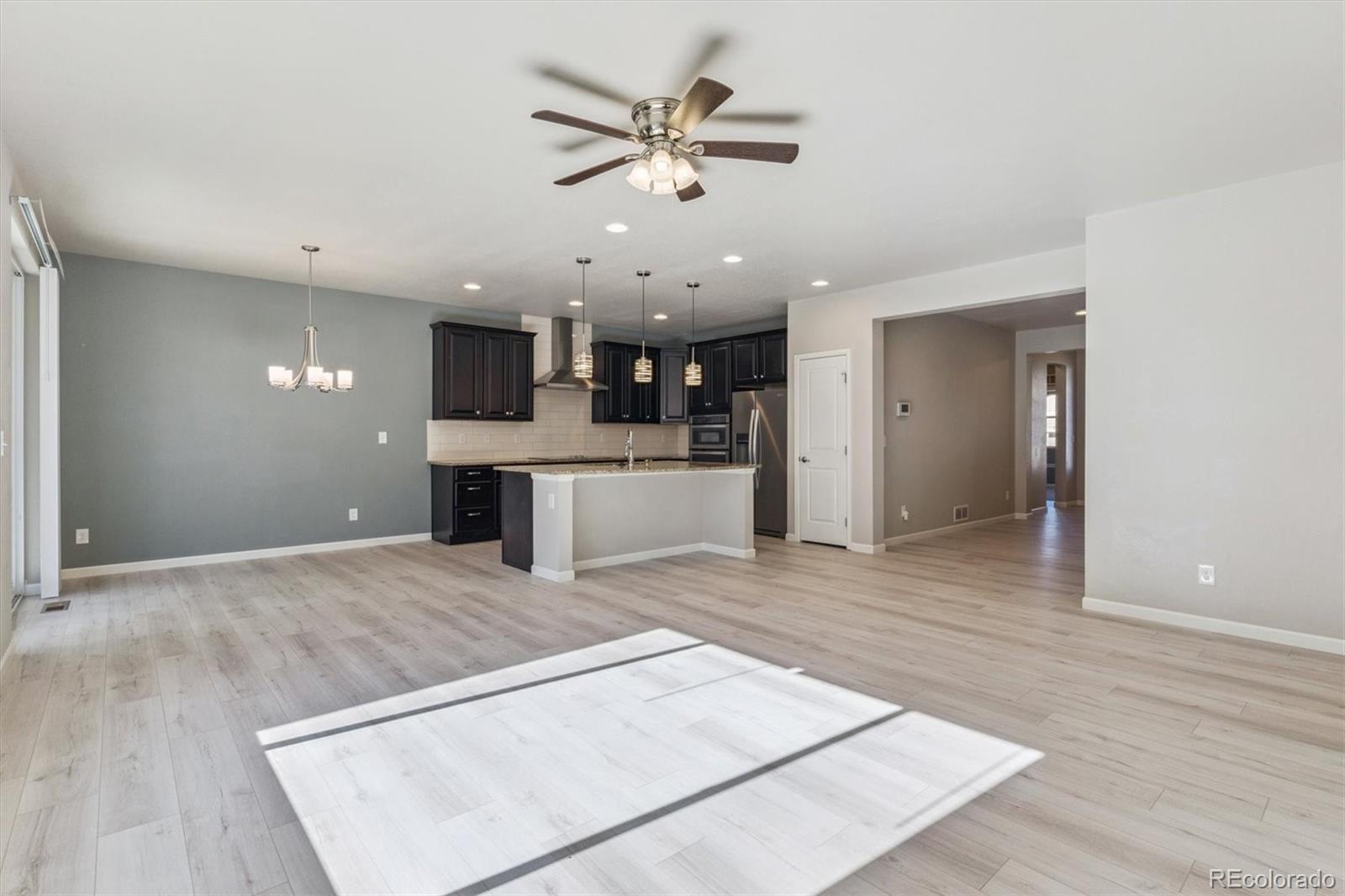 767 Wagon Bend Road Berthoud, CO 80513 - Photo 5 of 21 a view of kitchen with cabinets and wooden floor