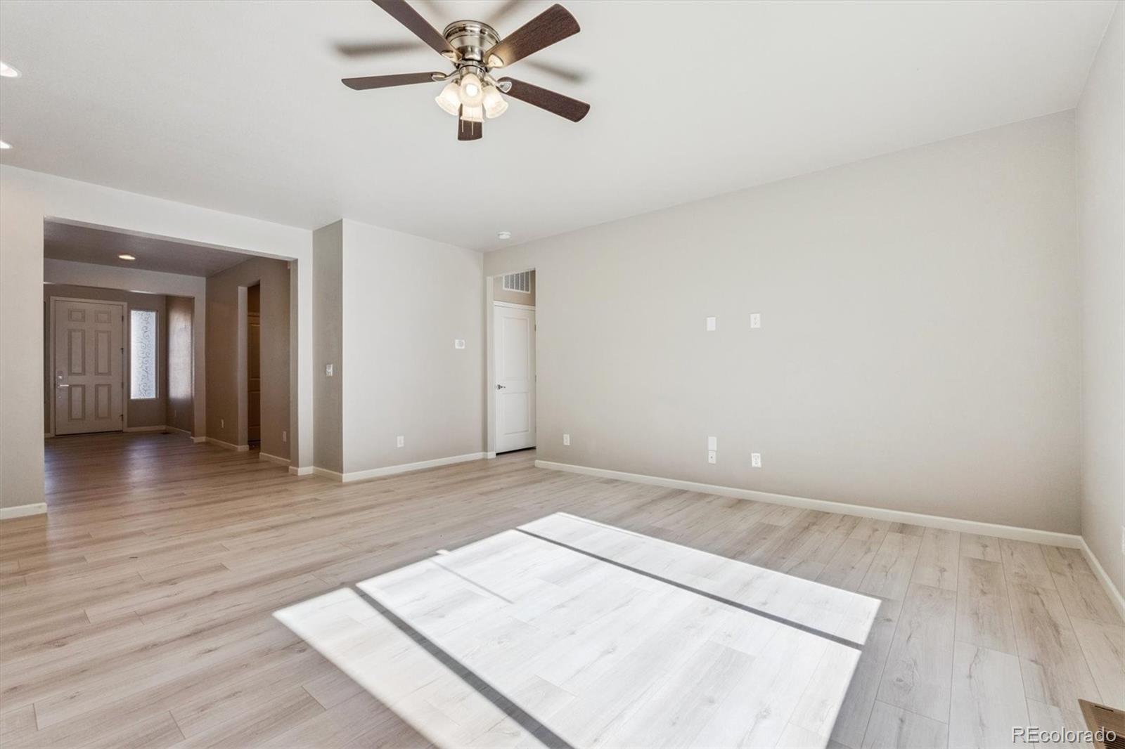 767 Wagon Bend Road Berthoud, CO 80513 - Photo 10 of 21 wooden floor in an empty room with a window