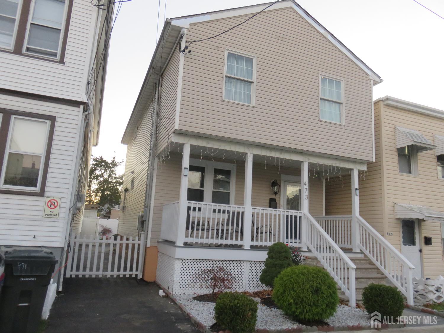473 Hall Avenue Perth Amboy, NJ 08861 - Photo 1 of 21 a front view of a house with a porch