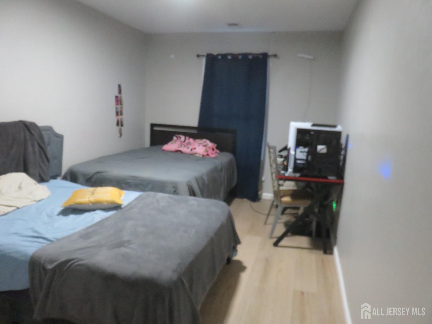 473 Hall Avenue Perth Amboy, NJ 08861 - Photo 12 of 21 a bedroom with a bed and a lamp