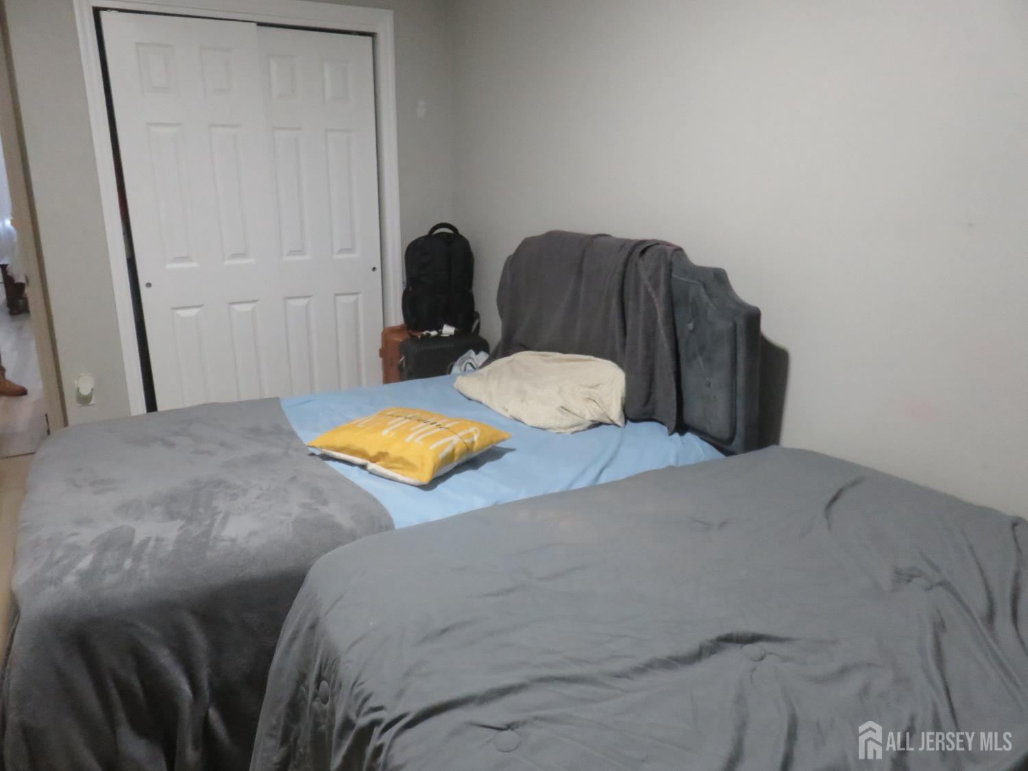 473 Hall Avenue Perth Amboy, NJ 08861 - Photo 13 of 21 a bedroom with a bed and chair