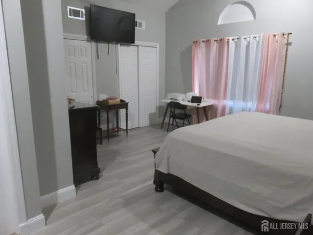 a bedroom with a bed and a television