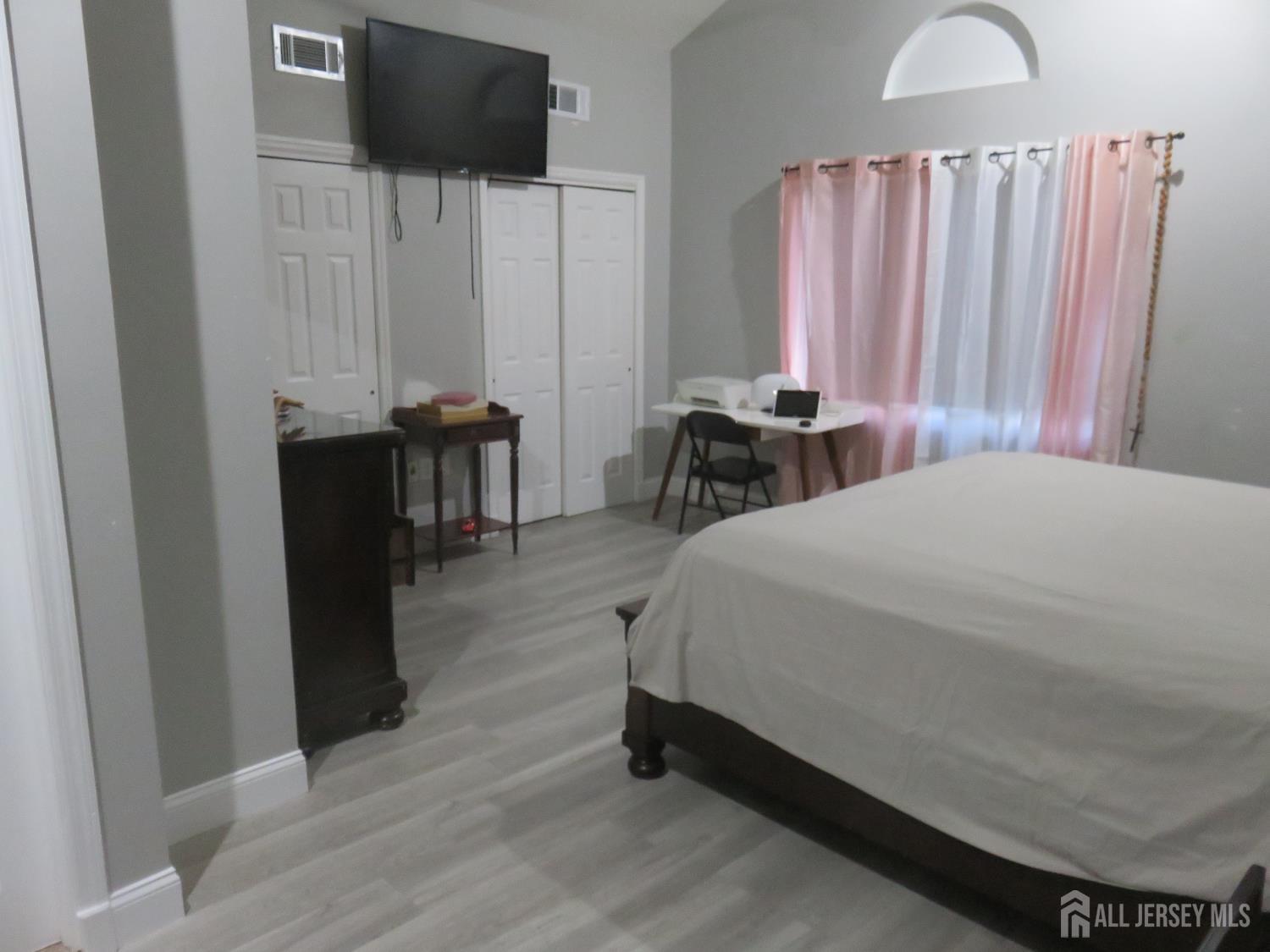 473 Hall Avenue Perth Amboy, NJ 08861 - Photo 15 of 21 a bedroom with a bed and a television