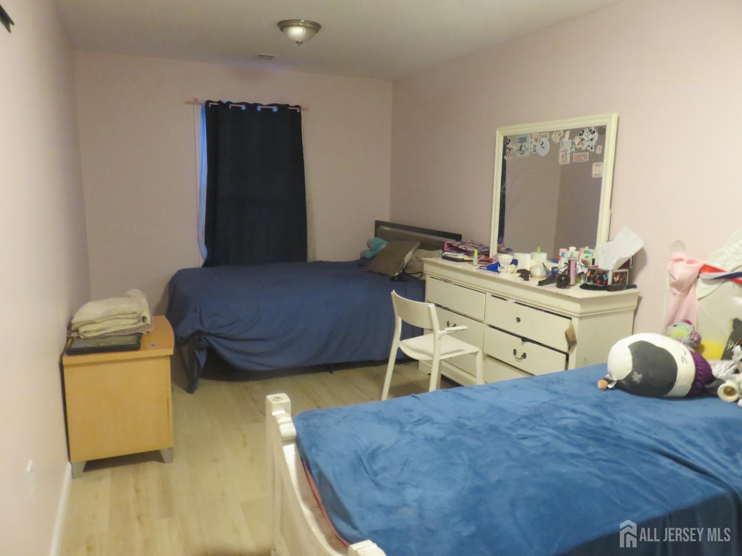 473 Hall Avenue Perth Amboy, NJ 08861 - Photo 17 of 21 a bedroom with a bed and wooden floor