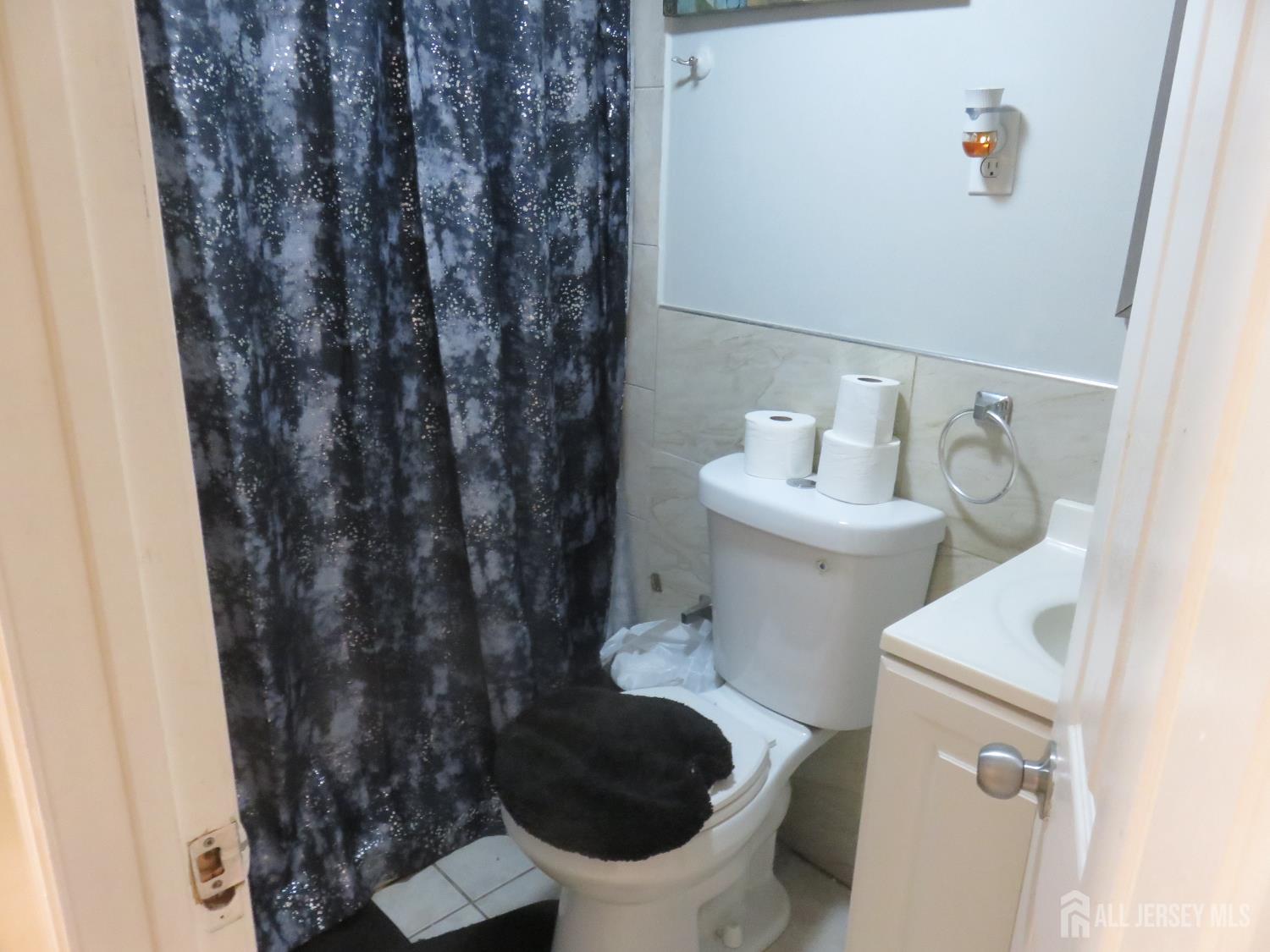 473 Hall Avenue Perth Amboy, NJ 08861 - Photo 18 of 21 a bathroom with a sink and a toilet