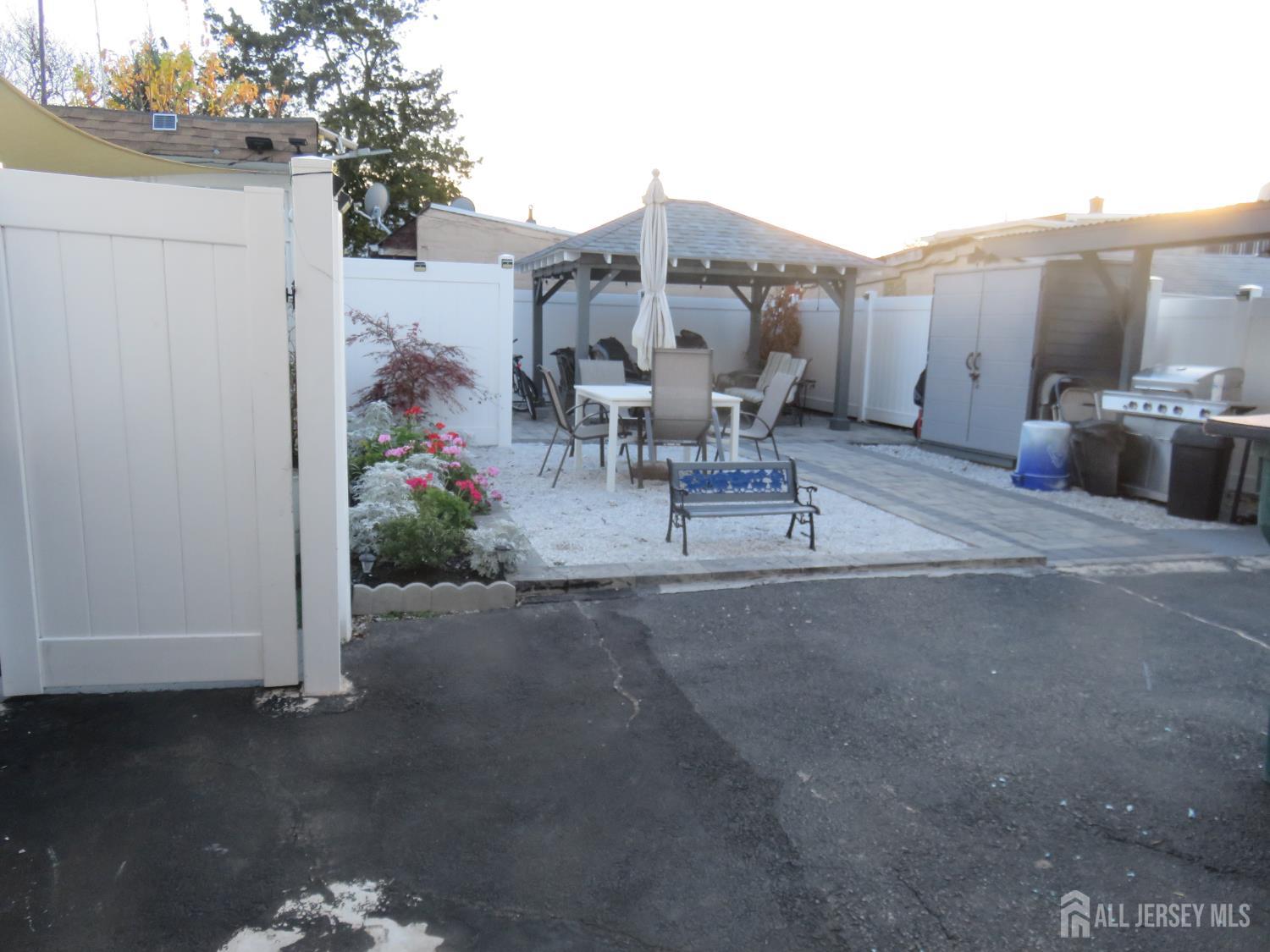 473 Hall Avenue Perth Amboy, NJ 08861 - Photo 2 of 21 a view of a patio with table and chairs and potted plants