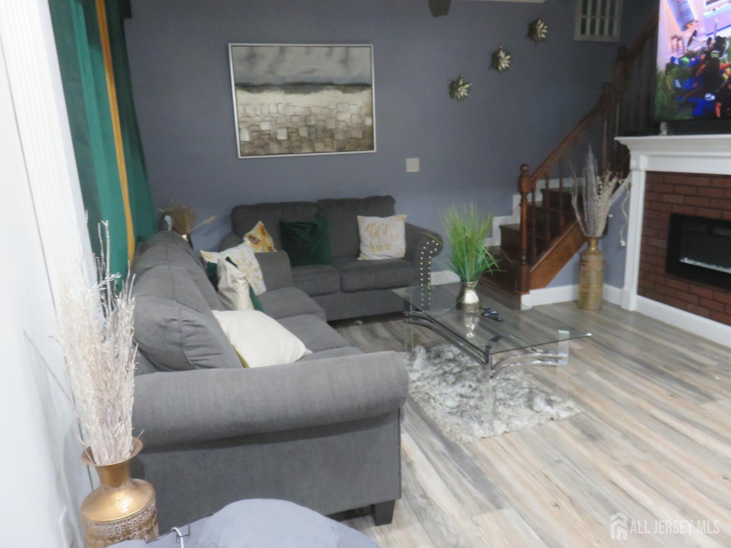 473 Hall Avenue Perth Amboy, NJ 08861 - Photo 6 of 21 a living room with furniture and a fireplace