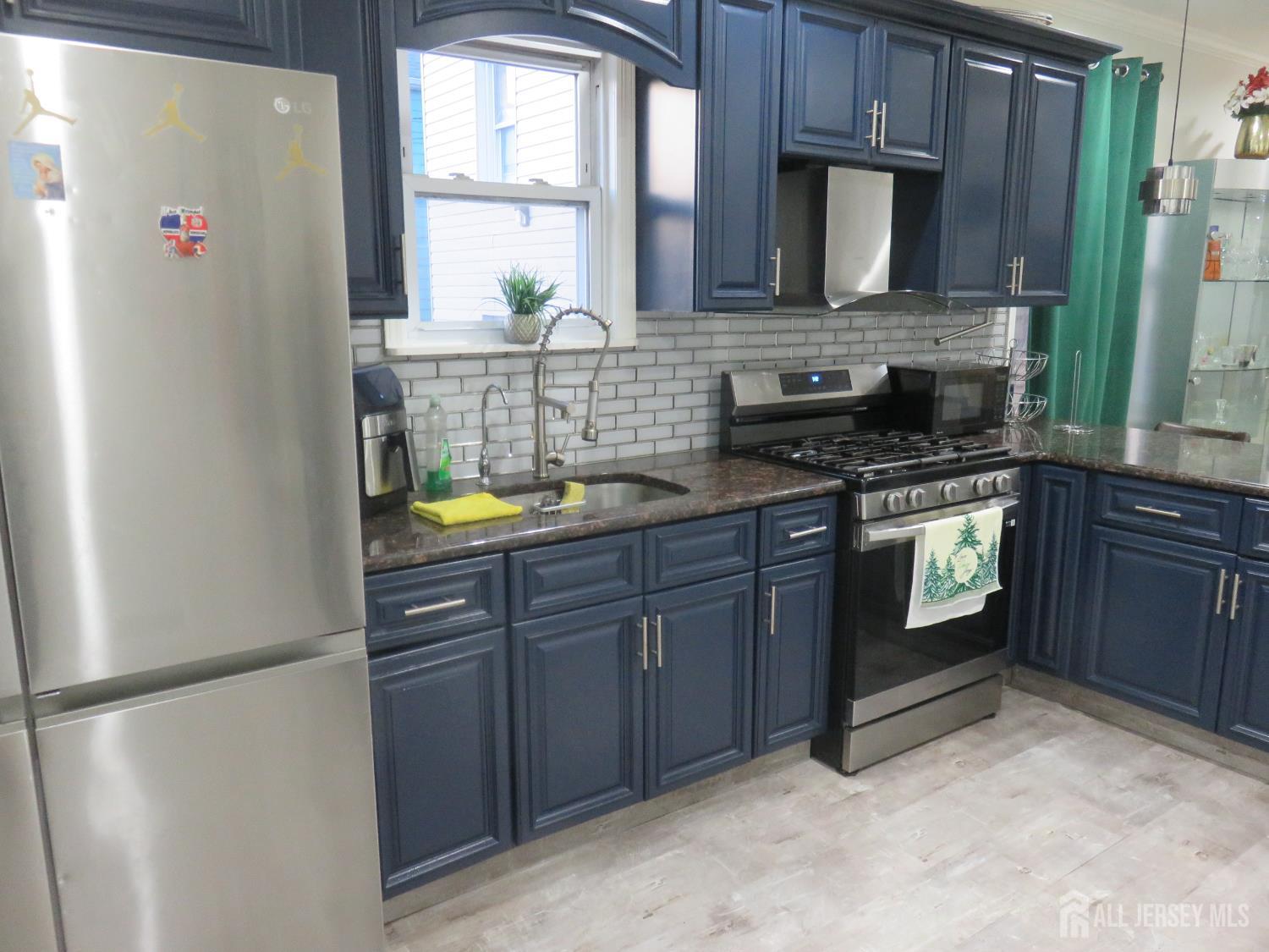 473 Hall Avenue Perth Amboy, NJ 08861 - Photo 8 of 21 a kitchen with a refrigerator sink and cabinets