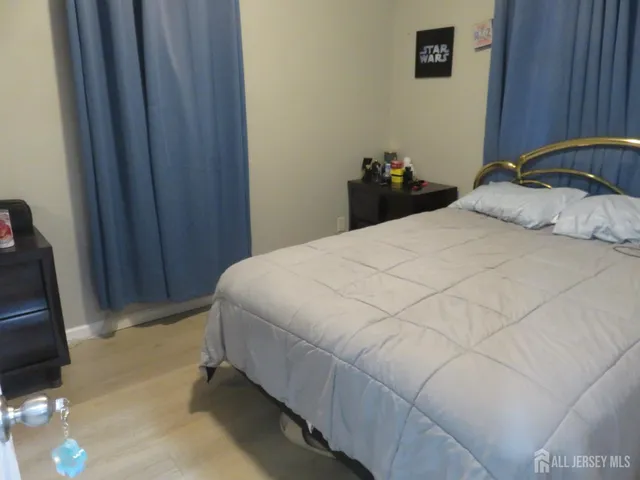 a bedroom with a bed and a mirror