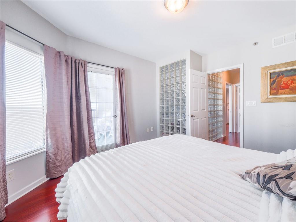275 13th Street Northeast, Unit 1106 Atlanta, GA 30309 - Photo 11 of 22 a bedroom with a large bed and a window