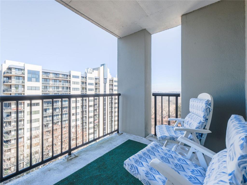 275 13th Street Northeast, Unit 1106 Atlanta, GA 30309 - Photo 13 of 22 a living room with furniture and a floor to ceiling window