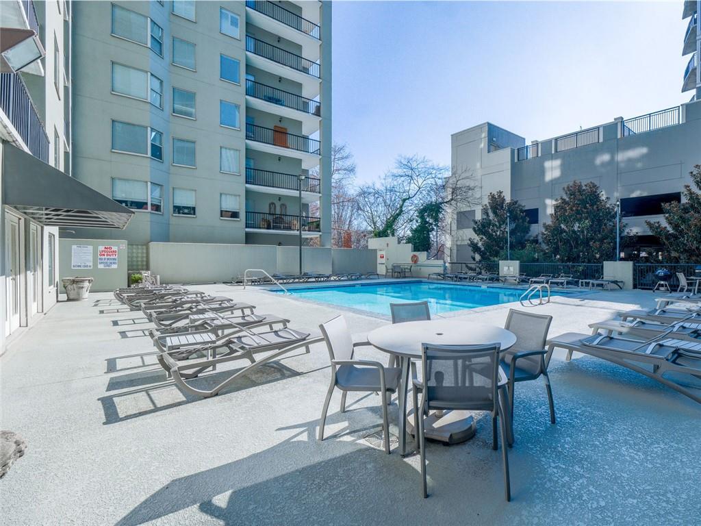 275 13th Street Northeast, Unit 1106 Atlanta, GA 30309 - Photo 16 of 22 a view of a patio with a table and chairs in patio