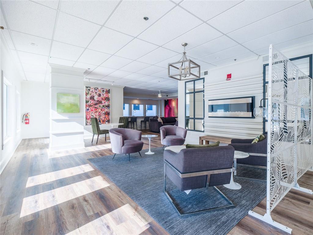275 13th Street Northeast, Unit 1106 Atlanta, GA 30309 - Photo 18 of 22 a living room with patio furniture and a chandelier