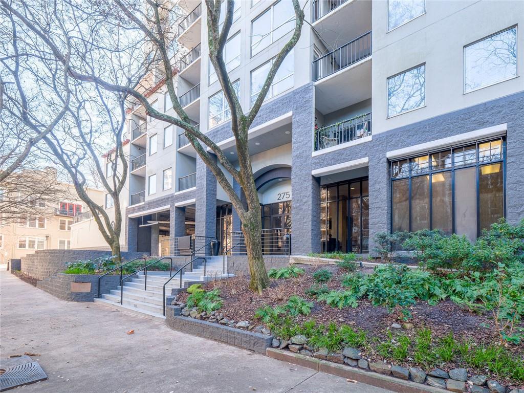 275 13th Street Northeast, Unit 1106 Atlanta, GA 30309 - Photo 3 of 22 a view of a brick building plants and large tree