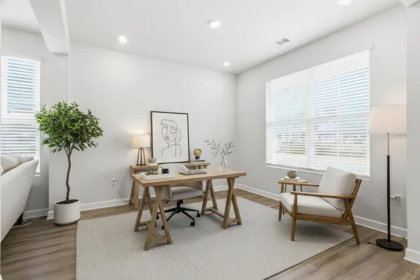 a workspace with furniture and a potted plant
