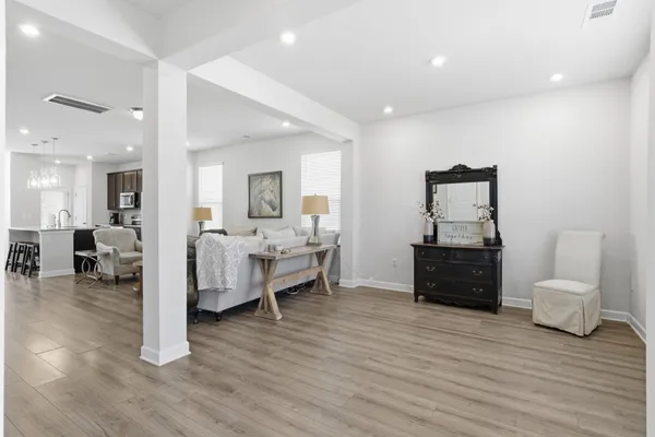 a living room with furniture and a mirror