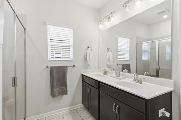 a bathroom with double sink and a mirror