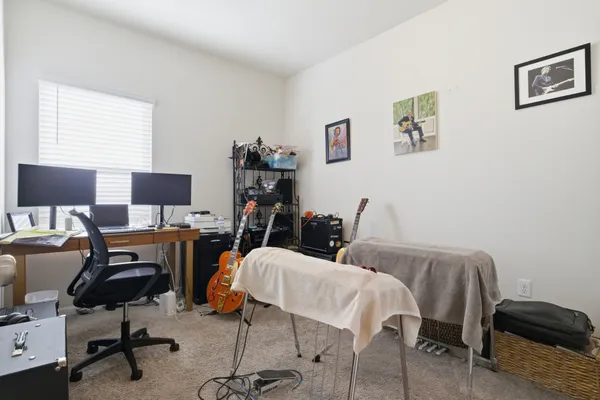 a view of a workspace with furniture and a window