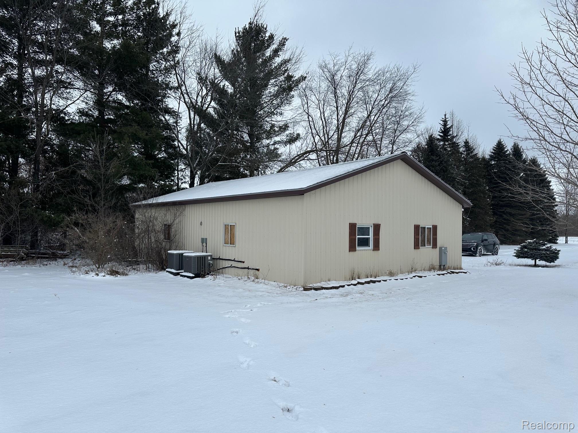 3803 Warner Road Cass City, MI 48726 - Photo 76 of 85 Snow covered property with an outbuilding and a central air condition unit