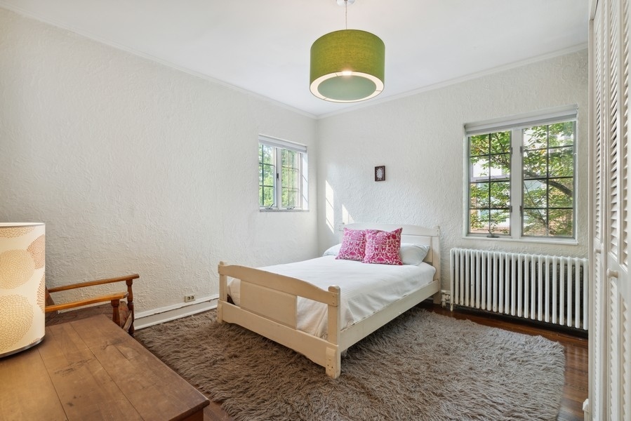 1116 East 48th Street Chicago, IL 60615 - Photo 15 of 25 a bedroom with a bed and a window