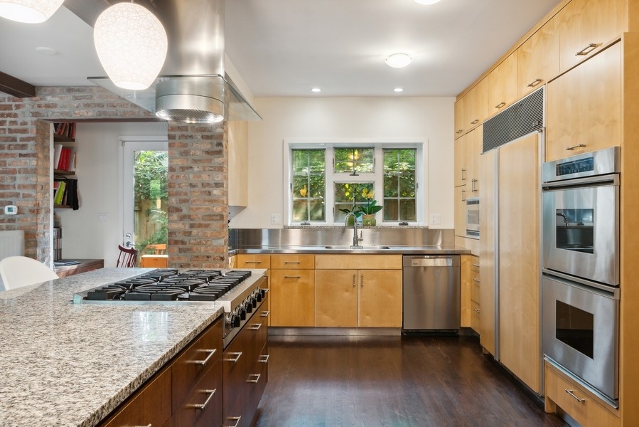 1116 East 48th Street Chicago, IL 60615 - Photo 8 of 25 a kitchen with stainless steel appliances granite countertop a refrigerator a stove and a wooden floors