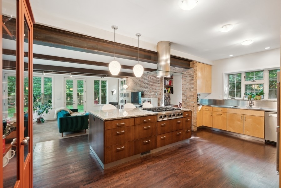 1116 East 48th Street Chicago, IL 60615 - Photo 9 of 25 a large kitchen with a large window and stainless steel appliances