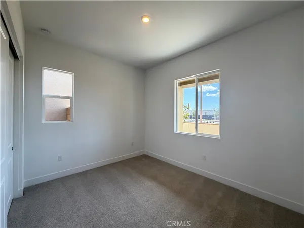 a view of an empty room and closet area