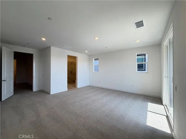 a spacious bathroom with a double vanity sink a large mirror and shower