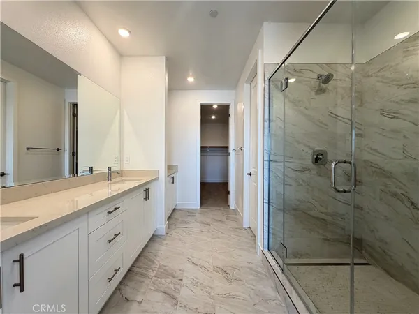 a bathroom with a shower and a sink