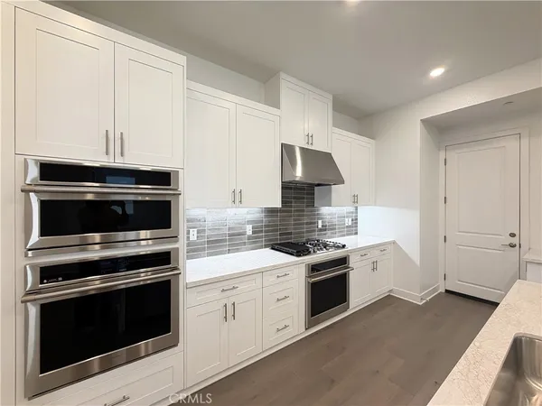 a kitchen with a stove a refrigerator and a sink