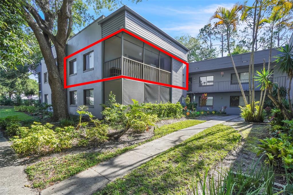 2329 Oak Park Way, Unit 204 Orlando, FL 32822 - Photo 1 of 1 a front view of multi story residential apartment building with yard and sign board
