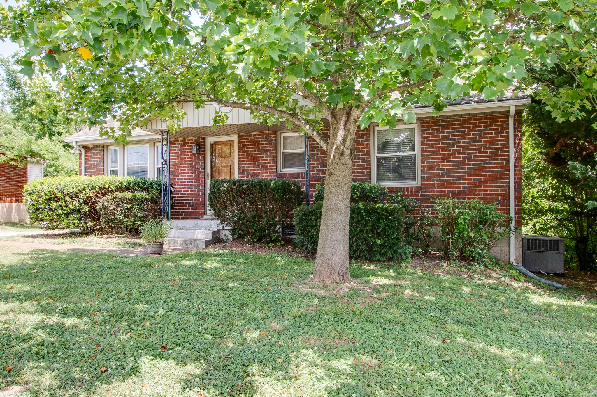 5002 Yorktown Road Nashville, TN 37211 - Photo 3 of 24 a front view of a house with a yard and tree