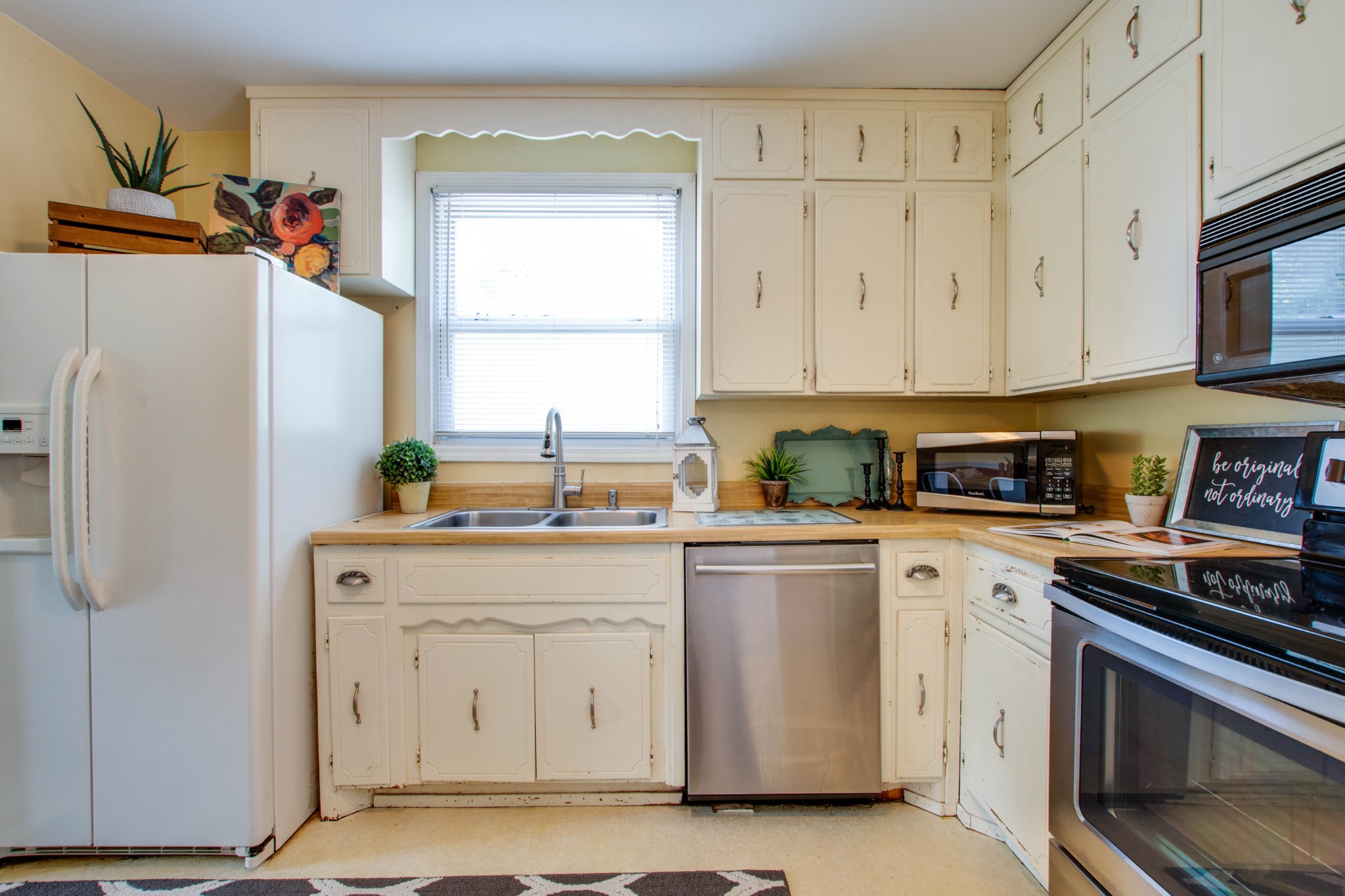 5002 Yorktown Road Nashville, TN 37211 - Photo 9 of 24 a kitchen with white cabinets and white appliances