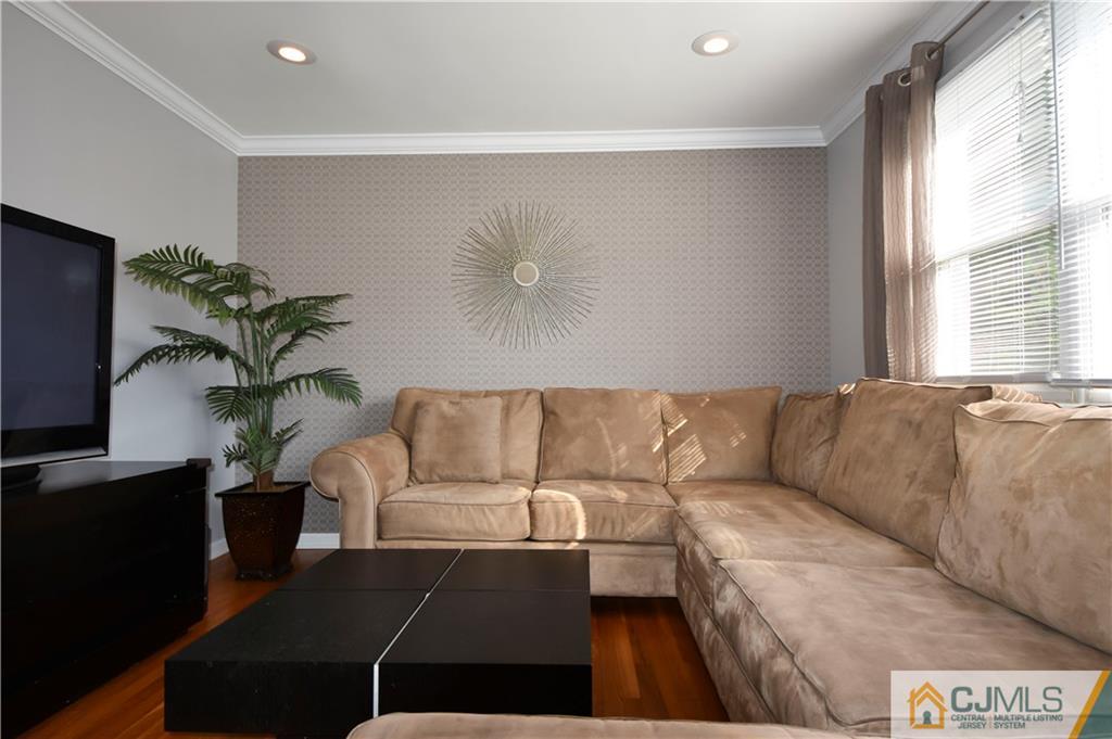 15 Thomas Road East Brunswick, NJ 08816 - Photo 3 of 20 a living room with furniture potted plant and a window