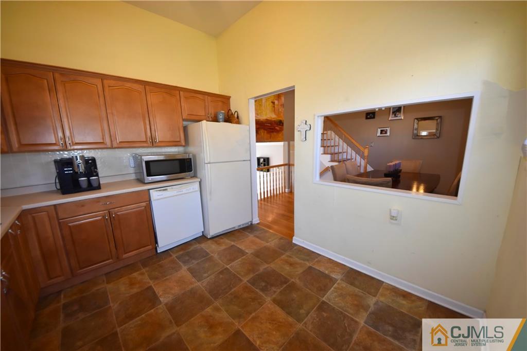 15 Thomas Road East Brunswick, NJ 08816 - Photo 8 of 20 a kitchen with stainless steel appliances a refrigerator and a stove top oven