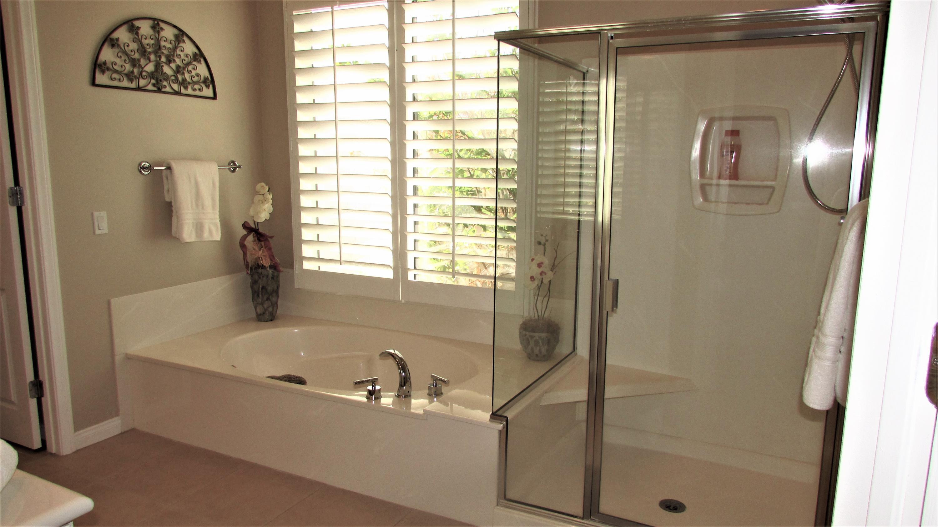 34 Paris Way Rancho Mirage, CA 92270 - Photo 17 of 35 a bathroom with a bathtub and a shower