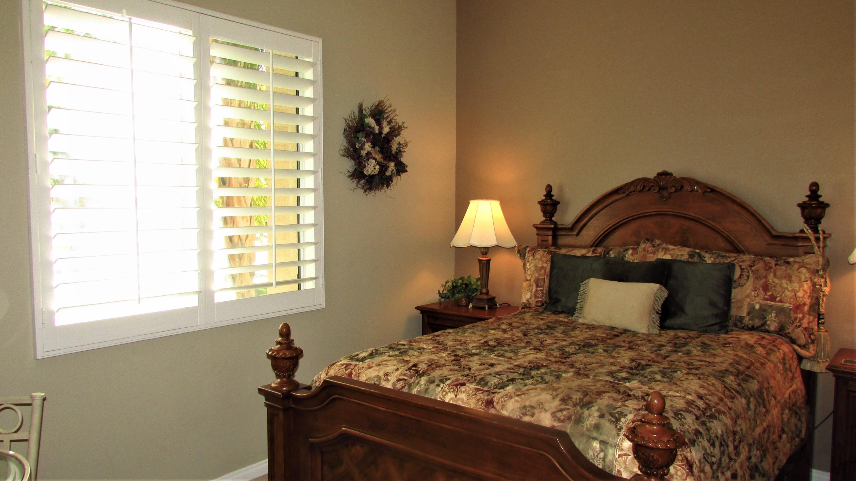 34 Paris Way Rancho Mirage, CA 92270 - Photo 19 of 35 a bedroom with a bed and a window