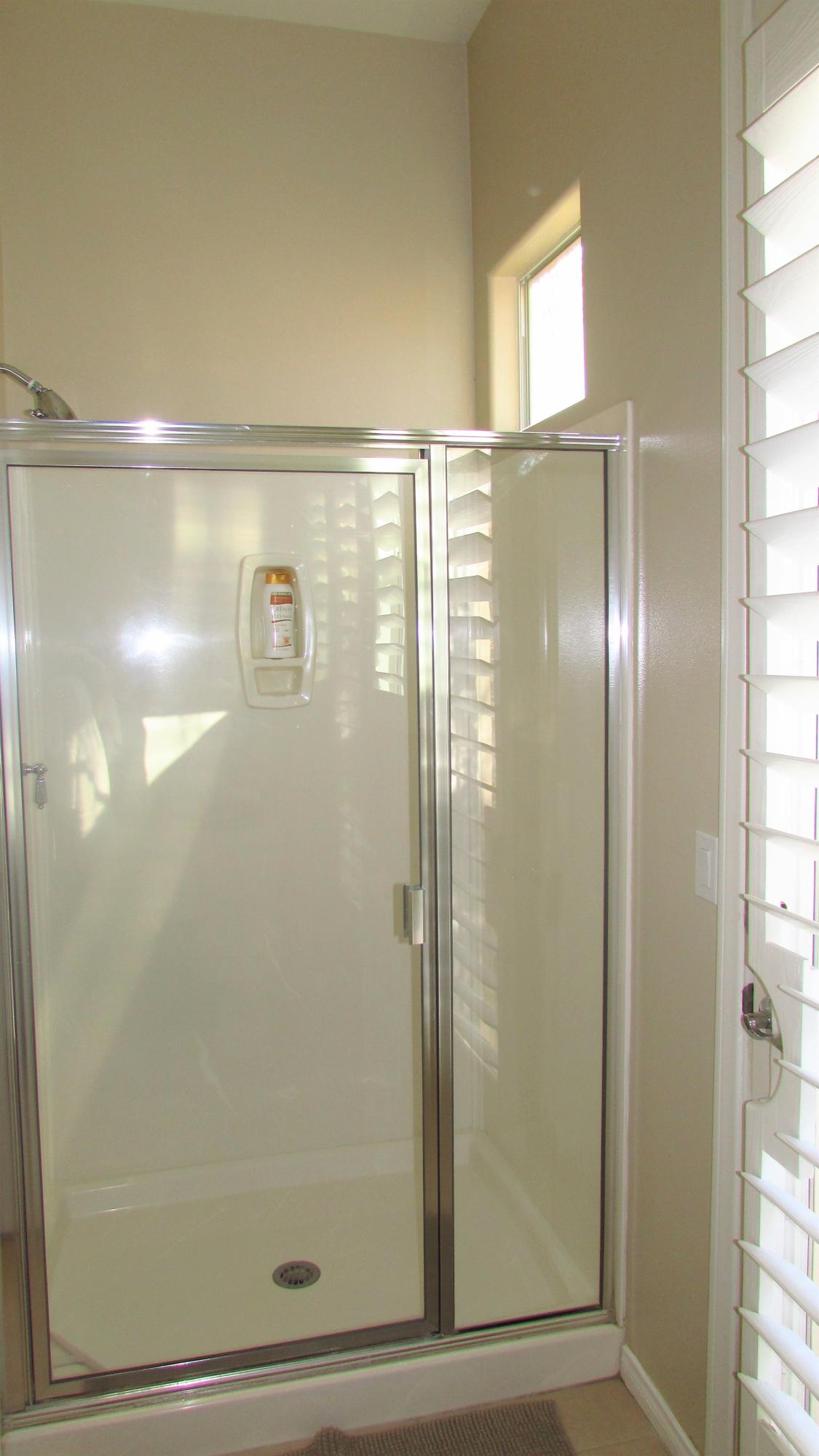 34 Paris Way Rancho Mirage, CA 92270 - Photo 23 of 35 a bathroom with a glass shower door