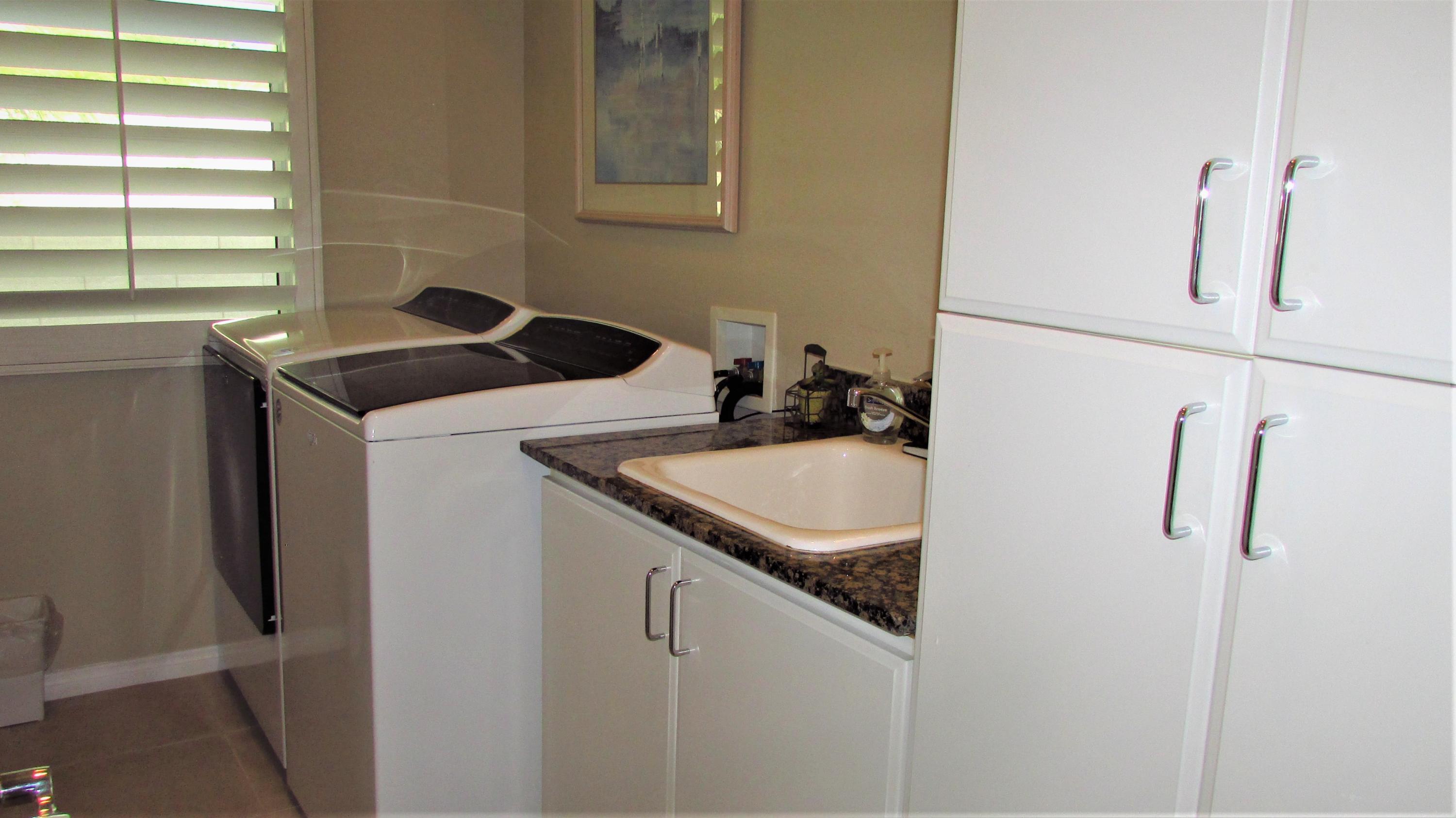 34 Paris Way Rancho Mirage, CA 92270 - Photo 28 of 35 a utility room with a sink dryer and washer