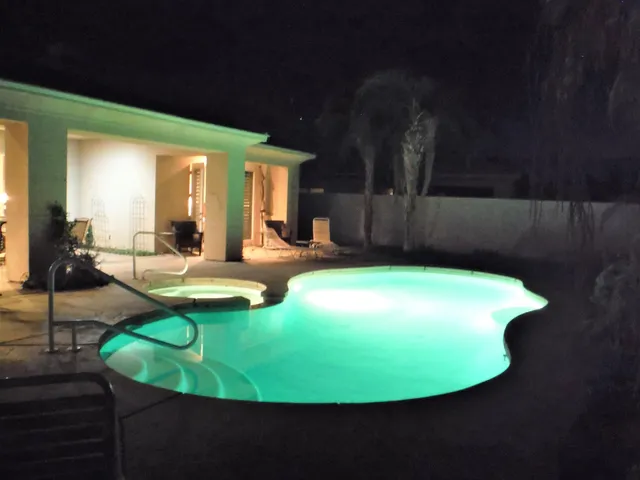 a view of a swimming pool with a yard