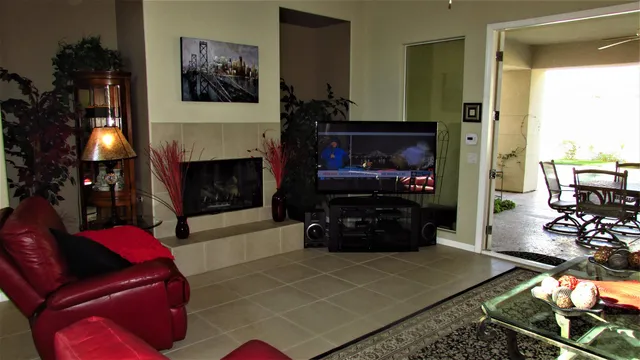 a living room with furniture a flat screen tv and a fireplace