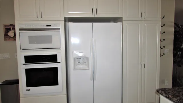 a kitchen with a table chairs sink and cabinets