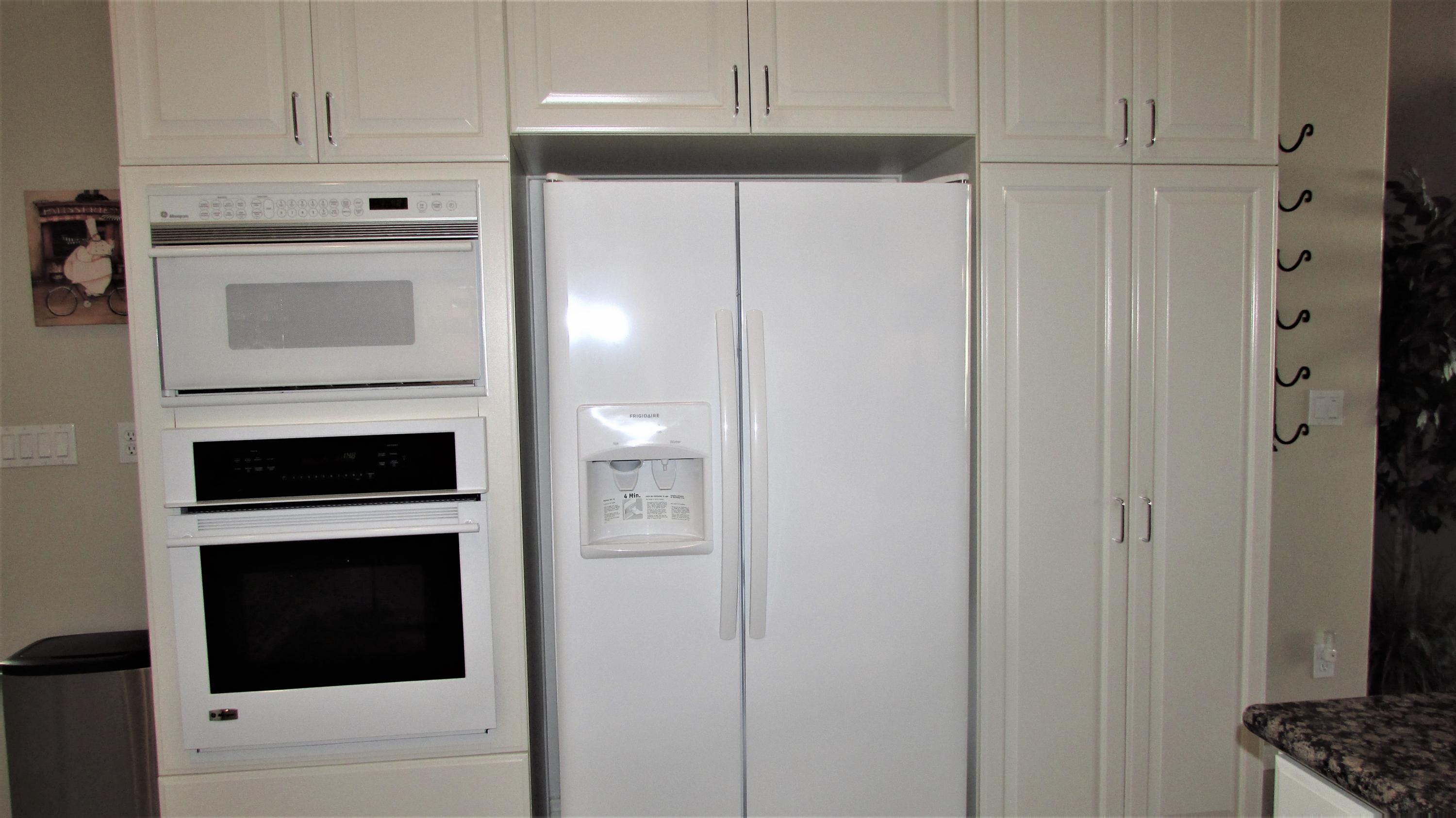 34 Paris Way Rancho Mirage, CA 92270 - Photo 10 of 35 a kitchen with cabinets and a refrigerator