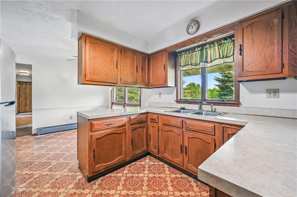 1011 South Lake Road Mercer, PA 16137 - Photo 8 of 22 a kitchen with stainless steel appliances granite countertop wooden cabinets a sink and a window